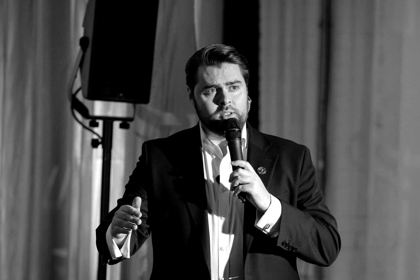 Rhys Morris hosting live on stage with a microphone