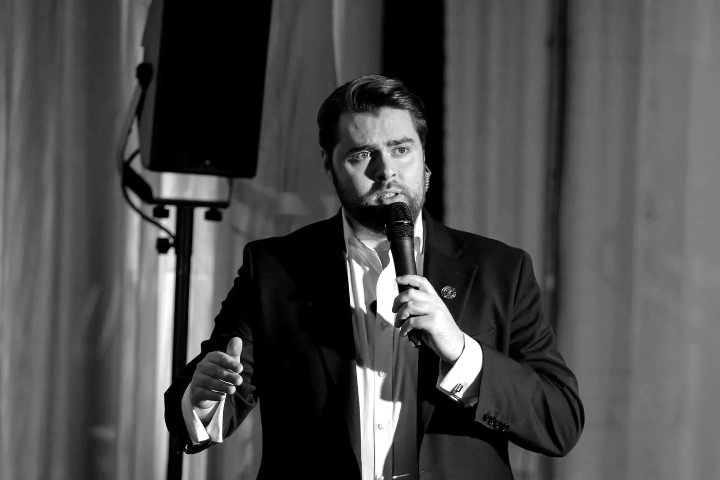 Rhys Morris hosting live on stage with a microphone