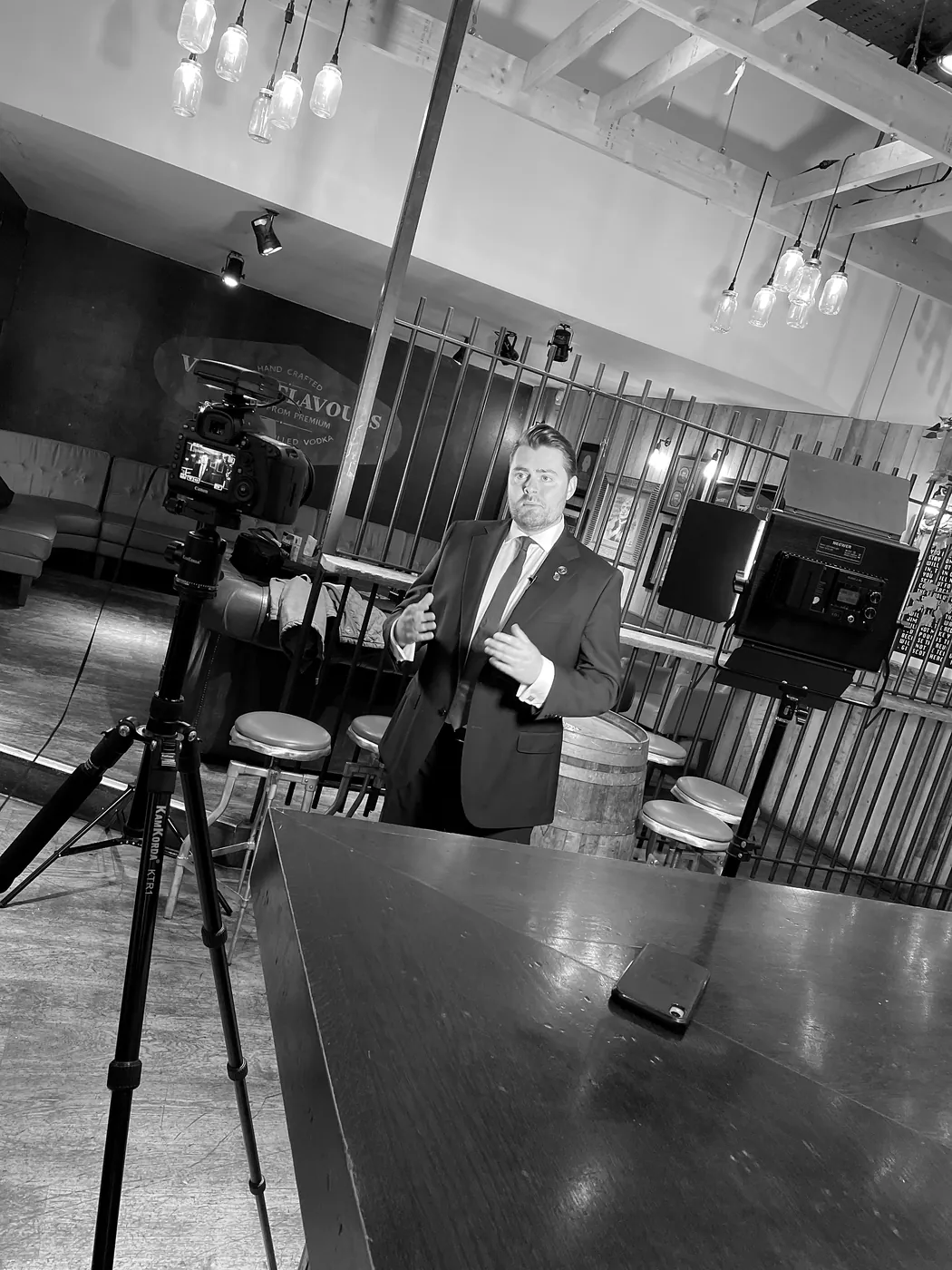 Rhys Morris filming a piece to camera between two cameras on a video shoot